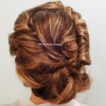Intricately styled updo with rich brown tones.