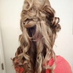 Curly blonde hair styled with volume and texture.