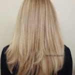 Back view of long, straight blonde hair with subtle layers.