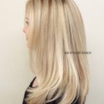 Side profile of a woman with sleek, straight blonde hair.