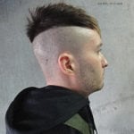 Side profile of a man with a mohawk hairstyle and shaved sides.