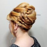 Elegant updo hairstyle with multiple braids pinned up.