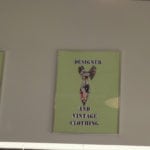 A vintage-style poster with a fashionable woman and text about vintage clothing.
