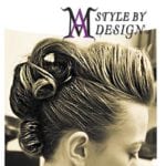 A close-up of an elegant hairstyle with hair rolled into curls.