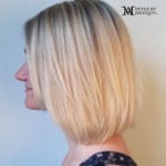 Side profile of a woman with a blonde bob haircut.