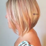 Side view of a woman with a short blonde bob haircut.
