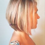 Profile view of a woman with a short blonde bob haircut.