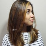 Portrait of a woman with straight brown hair looking sideways.