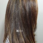 Close-up of straight, brown hair with subtle highlights.