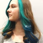 A woman with long brown hair dyed blue and teal.