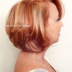 Profile of a woman with short, layered auburn hair.