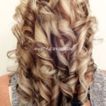 Close-up of blonde hair styled in tight curls.