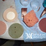 A collection of variously shaped ceramic or clay plates and bowls on a table.