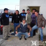 A group of young men posing outside a building.
