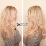 Side profile of a woman with long, wavy blonde hair.