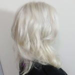 Side profile of a person with platinum blonde hair.