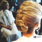 Woman with elegant blonde updo hairstyle.