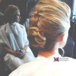 Woman with an elegant braided updo hairstyle.