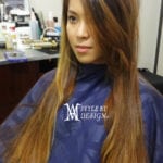 A woman with long straight brown hair in a salon.