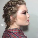Profile of a woman with braided hair and makeup.