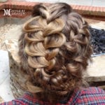 Intricate braided hairstyle with voluminous curls.