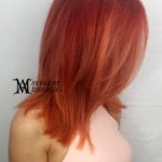 Woman with shoulder-length, straight red hair.