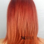Back view of straight, shoulder-length reddish-orange hair.