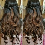 Long wavy brown hair styled with a half-up bow knot.