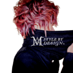 Person with vibrant pink curly hair wearing a black jacket.