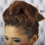 Elegant updo hairstyle with a smooth finish and volume.