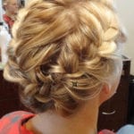 Elegant braided updo hairstyle with blonde highlights.