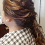 Woman with a styled braid and highlights in her hair.