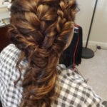 Intricate braided hairstyle with multiple thick braids woven together.
