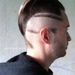 A man with a unique shaved hairstyle featuring geometric patterns.