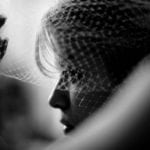 Black and white close-up of a woman in profile with a veil.