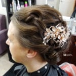 Elegant bridal hairstyle with a floral hair accessory.
