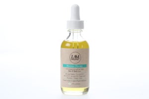 A clear dropper bottle with yellow liquid and a beige label.