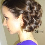 A side profile of a woman with an elegant updo hairstyle.