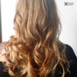 Long, wavy blonde hair cascading down the back.