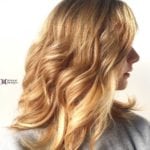 Profile of a woman with wavy blonde hair.