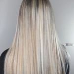 Straight blonde hair with subtle highlights.