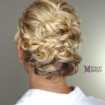 Elegant blonde updo hairstyle with curls.