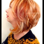 Side profile of a woman with short, layered blonde hair.