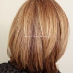 A medium-length hairstyle with blonde highlights.
