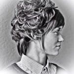 Black and white side profile portrait of a woman with short curly hair.