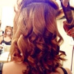 A person with freshly curled brown hair.