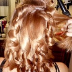 Curly hairstyle being styled on light brown hair.