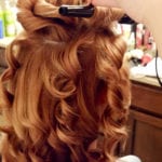 Close-up of styled curly hair held by a clip.