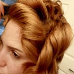 Close-up of a woman with styled golden blonde hair.