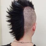 Back view of a person with a black spiked mohawk hairstyle.